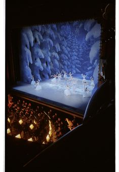 the stage is lit up with white lights and decorations on it, as well as several small figurines