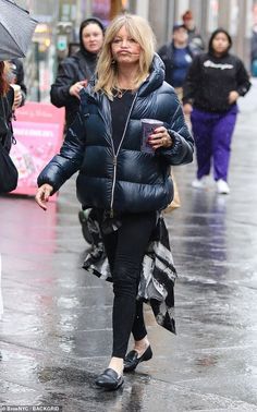 a woman walking down the street with an umbrella