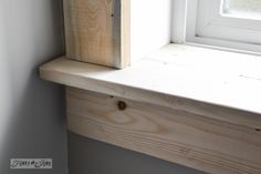 a window sill with a wooden block on it