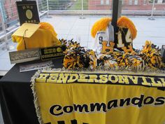 the table is set up with decorations and books for football fans to sign on it