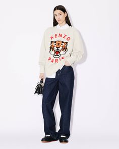 This sweatshirt features a unique mascot, the new 'KENZO Lucky Tiger', as a reminder of KENZO's history. This motif embodies Nigo’s carefree spirit in a style identical to Kenzo Takada’s Elephant. The oversized fit creates a modern silhouette for both men and women.
'KENZO Lucky Tiger' oversized sweatshirt.Genderless.Long sleeves.Round neckline.'Lucky Tiger' chain-stitch embroidery on the front.'KENZO Paris' woven label on the back.Ribbed detailing. Streetwear Fashion Sweatshirts, Chain Stitch Sweatshirt, French Terry Sweatshirt With Embroidered Logo For Streetwear, Kenzo Outfit Women, Collegiate French Terry Sweatshirt, Kenzo Paris, Oversized Sweatshirt Outfit, Kenzo Sweatshirt Outfit Women, Kenzo Hoodie