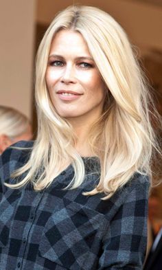 a blonde woman with long hair wearing a black and white checkered shirt