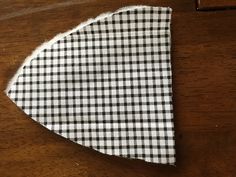 a black and white checkered cloth on top of a wooden table