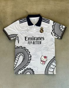 a white shirt with an image of a dragon on the front, and a hello kitty on the back