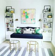 a living room filled with furniture and lots of bookshelves on top of it