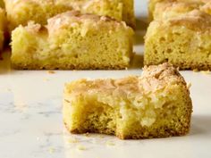 several pieces of cake sitting on top of a counter