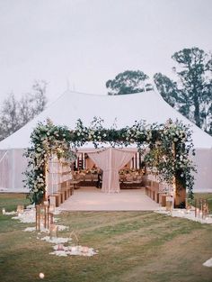 an outdoor wedding setup with flowers and greenery