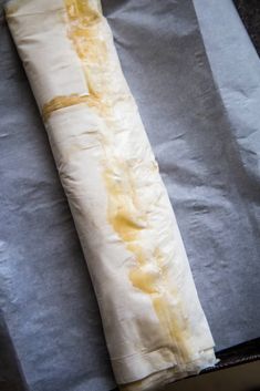 an unwrapped pastry sitting on top of a piece of paper