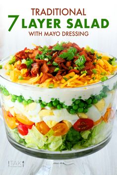 a layered salad in a glass bowl with text overlay reading 7 traditional layer salad with mayo dressing