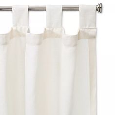 a white curtain hanging on the side of a metal rod with an eyelet in front of it