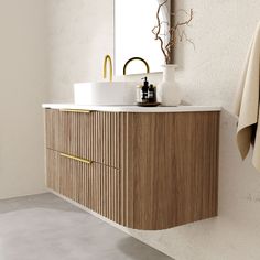 a bathroom with a sink, mirror and towel hanging on the wall next to it