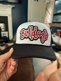 This listing is for the Bulldogs trucker hat in black with white front. Includes the bulldogs script painted on with rhinestones. I can make other custom school mascot or name hats too so just send me a message and we can work out a personalized hat just for you! DETAILS- * This hat is one size with an adjustable SnapBack that is adjustable from 20in. - 23.5in. * The color of this hat is black with white front * The material of the hat is polyester with hand paint and rhinestones glued on REFUNDS AND CANCELLATIONS- Every hat is handmade by me as a result, a slight variation can occur from the picture with patch size or placement. If you have any problems with your hat please message me within 24 hours of receiving your order and I'd be happy to help! No refunds or exchanges will be accepte Painted Trucker Hats, Personalized Hat, College Hats, Trendy Hats, Bling Hat, Painted Hats, Trendy Hat, University Of Georgia, Hand Paint