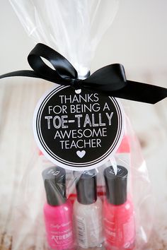 some pink and black nail polish in a bag