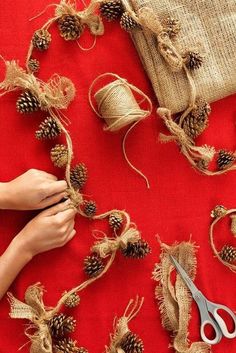 someone is working on some twine and pine cones