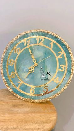 a clock sitting on top of a wooden table