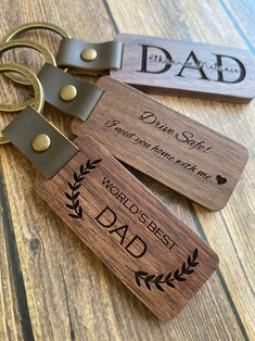 two wooden key chains with engraved words on them, one for dad and the other for daughter