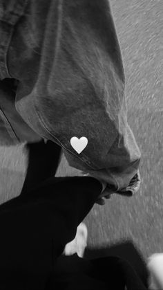 a person riding on the back of a motorcycle with a heart sticker on it's side