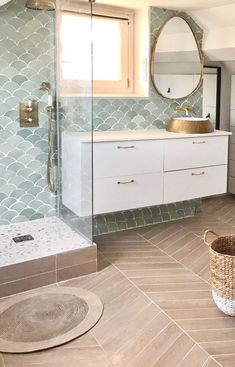 a bathroom with a sink, mirror and shower stall in the middle of the room