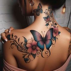 the back of a woman's neck with flowers and butterflies on it