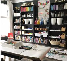 the room has many bookshelves and craft supplies on it