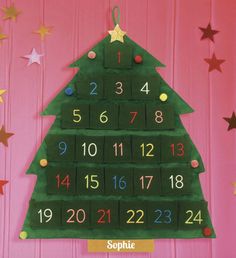 a christmas tree shaped calendar hanging on a wall