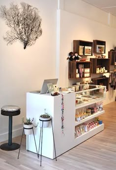 the inside of a clothing store with two stools in front of it and shelves on the wall