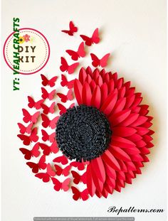 a red and black paper sunflower surrounded by butterflies on a white background with the words diy kit written below it