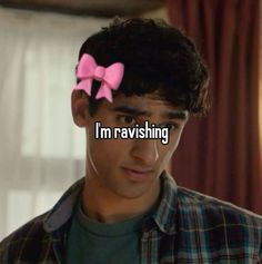 a man with a pink bow on his head and the words i'm raviishing