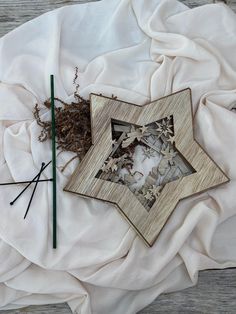 an image of a star cut out with scissors on a white cloth next to it