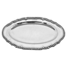 an oval silver tray with beaded edges