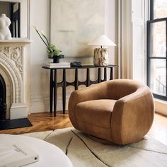 a living room filled with furniture and a fire place in front of a painting on the wall