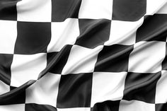 the black and white checkered fabric is waving in the wind