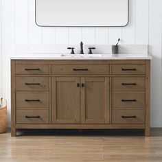 a bathroom vanity with two sinks and a large mirror above it on a white wall