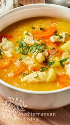 a white bowl filled with soup on top of a wooden table