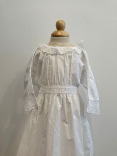 Beautiful antique Victorian 1900s white lace cotton christening dress. Could also be worn at a photo shoot. Original tie and button at the back of the garment. With long tie that bows at the back of the garment. Handmade cotton lace graces the garment on the waist,neck and skirt of the dress.  There is a pin hole on the shoulder of the dress, lace is coming away from the shoulder section, and slight yellowing on the shoulder and skirt of the dress( not noticeable when on)  As this is a antique d Victorian White Dress, White Victorian Dress, White Baptism Dress, Baby Blessing Dress, Vintage White Dress, Vampire Dress, Girls Baptism Dress, Baptism Dress Baby Girl, White Tulle Dress