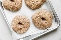 four doughnuts sitting on top of a baking sheet