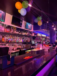 a bar with balloons hanging from the ceiling