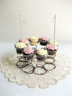 several cupcakes are arranged on a doily