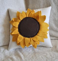 a sunflower pillow on a bed with the words pattern written in black and white