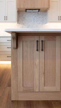 a kitchen with wooden cabinets and white counter tops