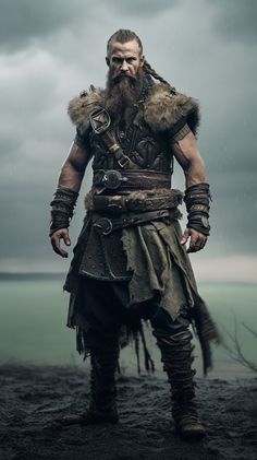 a man with long hair and beard standing in front of the ocean on a cloudy day