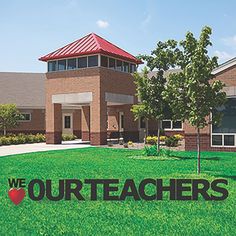 we love our teachers sign in front of a building with trees and grass on the lawn