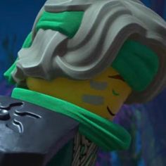 a close up of a lego character wearing a green and white hat with his head tilted to the side