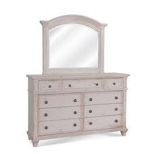 a white dresser with a mirror on top and drawers below it, against a white background