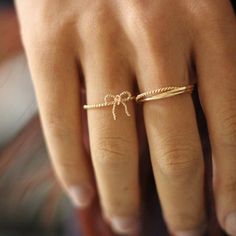 Our Dainty Bow Ring, is the perfect trendy yet timeless tiny gold ring to add to your collection. The perfect stackable ring, our Ribbon ring is handmade with a delicate twist rope style band and is available in either 14k Gold Fill and Sterling Silver coming soon! ∙ Gift Ready in a jewelry box! ∙ Handmade in Vancouver, Canada.  ∙ 100% 14k Gold Fill (and Sterling Silver coming soon!) --------------------------------- M E A S U R E M E N T :  Width: 1.3mm Bow: approx. 10x10mm (please note the bow Dainty Midi Rings For Gifts, Dainty Gold Midi Rings, Dainty Rose Gold Initial Ring, Dainty Tiny Initial Ring, Dainty Adjustable Midi Rings For Promise, Dainty Infinity Midi Rings For Gift, Dainty Infinity Midi Rings As Gift, Adjustable Dainty Midi Rings, Rose Gold Plated Midi Rings For Wedding