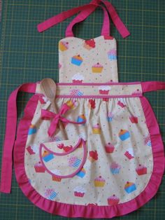 an apron and bib made to look like it has cupcakes on it