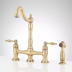 an antique brass faucet with two handles