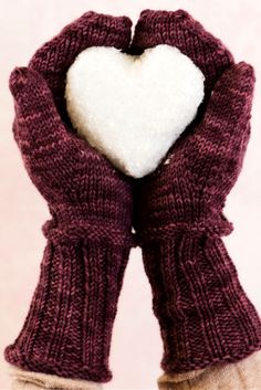 a pair of gloves with a white heart in the middle