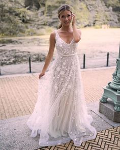 a woman in a wedding dress talking on her cell phone