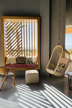 a living room filled with furniture and a hanging chair